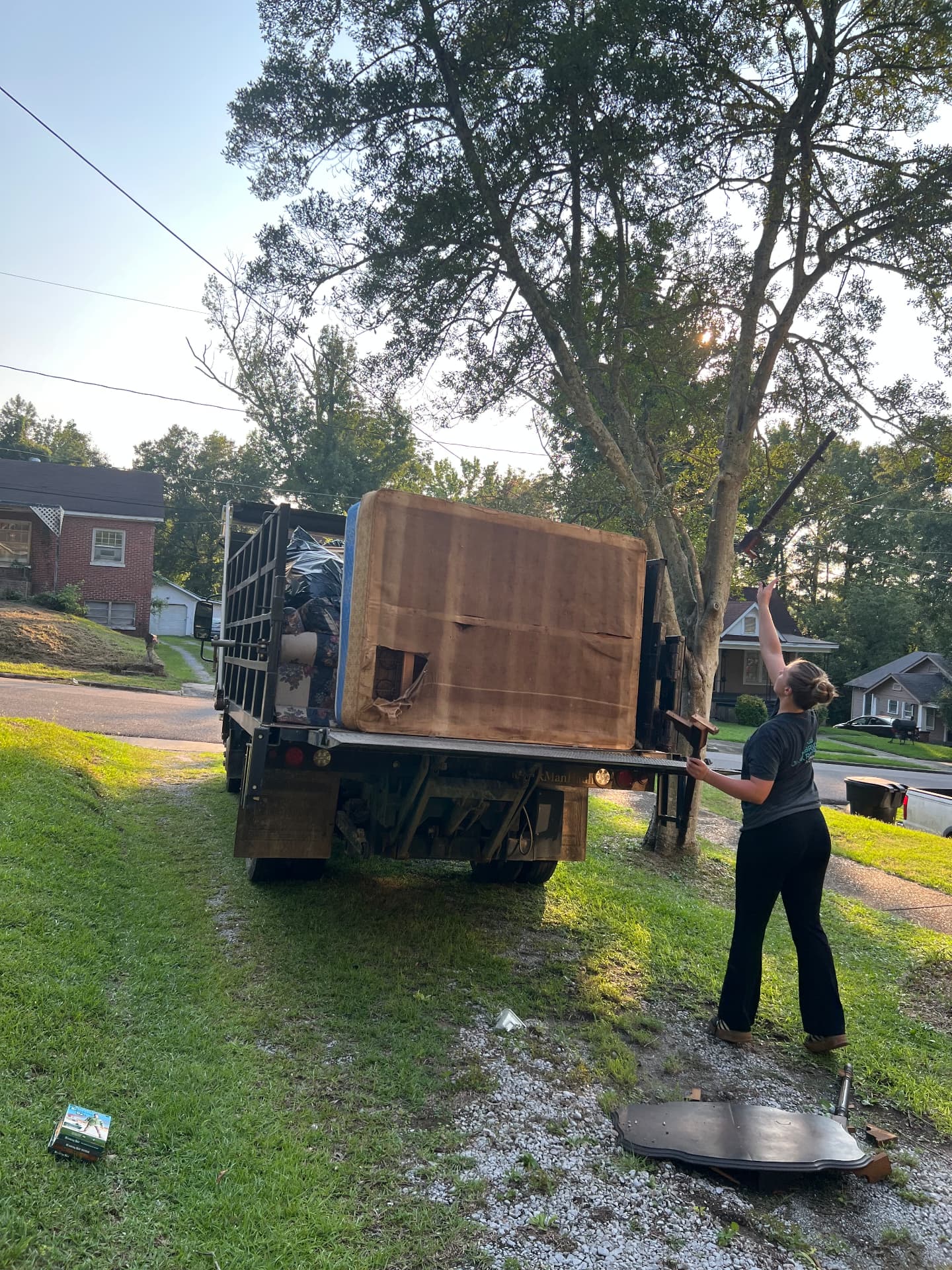 Mattress and household junk loaded on the dump truck with the liftgate down