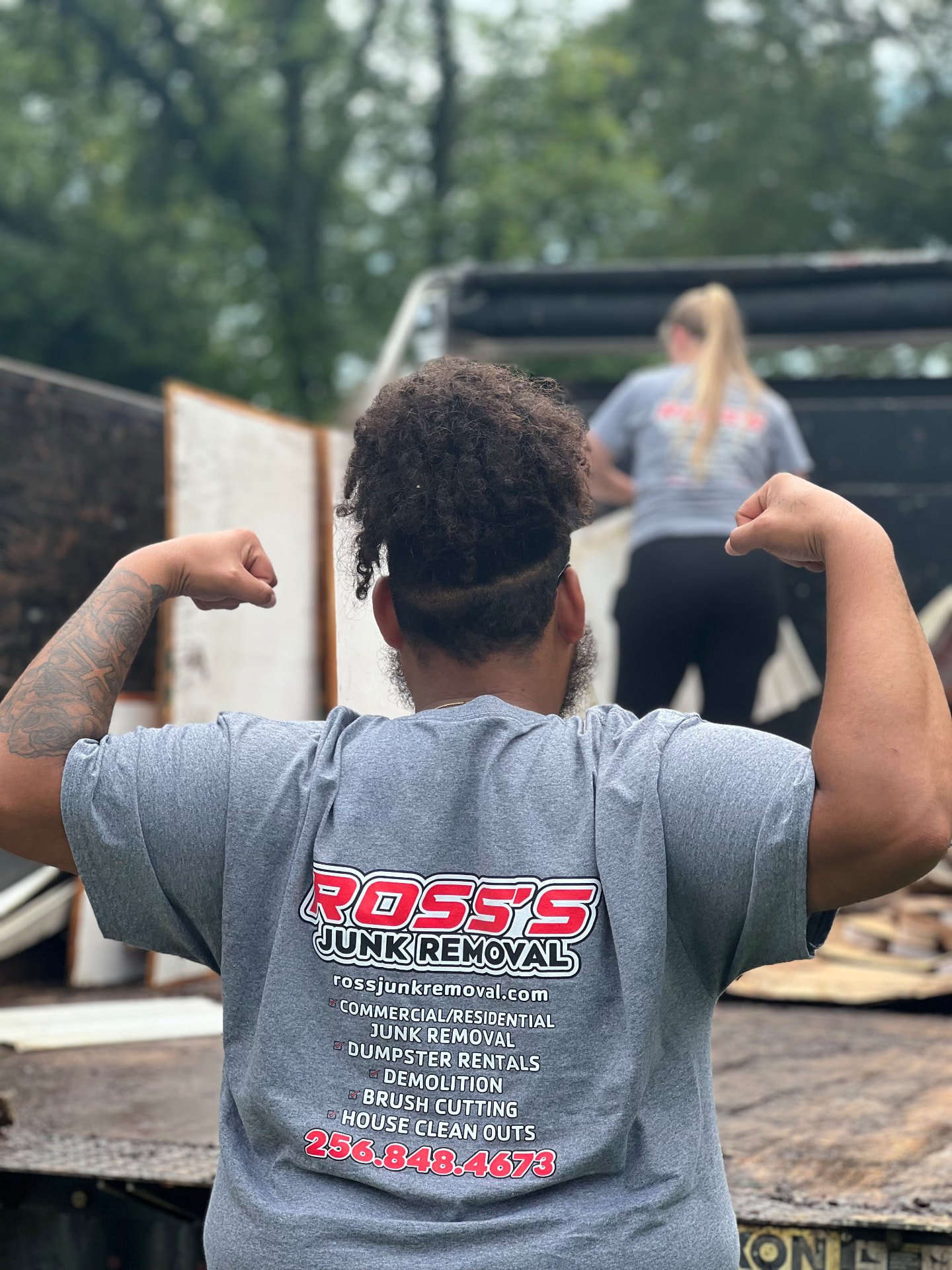 Ross's Junk Removal team member loading a truck during a junk removal job