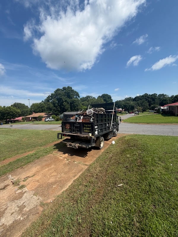 Loaded dump truck on site after a yard and household junk pickup